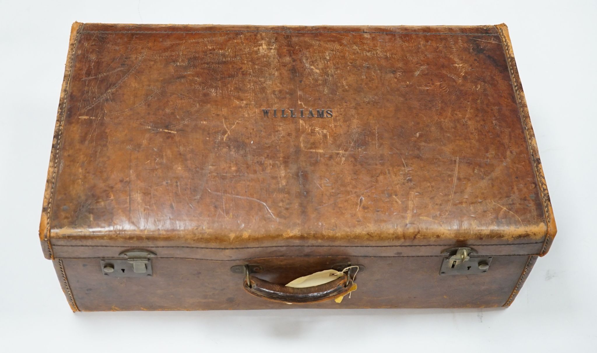 A leather suitcase., 77cms wide x 27 cms high.